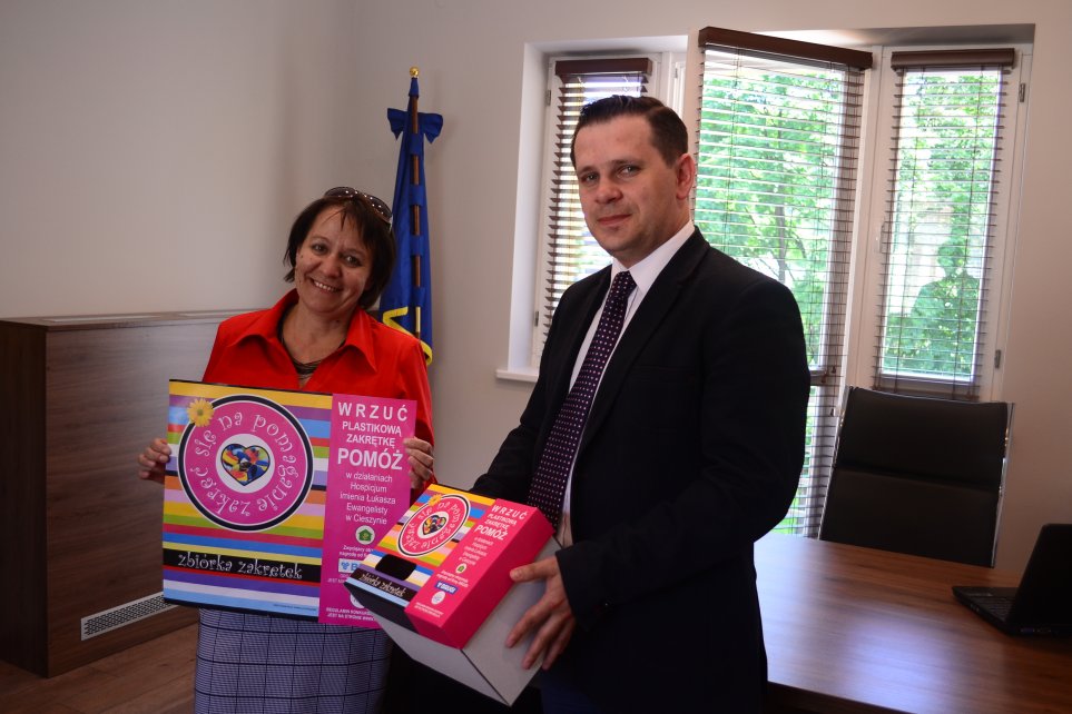 Burmistrz Tomasz Bujok i dyrektor Hospicjum Dorota Kania prezentują plakat i pudełko związane z akcją
